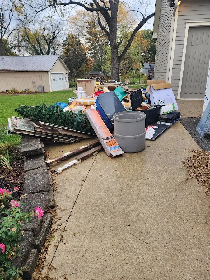 Dumpster being loaded with debris for Roofing Dumpster Rental in Dyersville